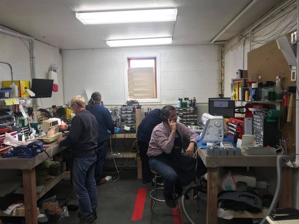 technicians repairing sewing machine s